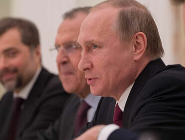 Vladimir Putin at a desk.