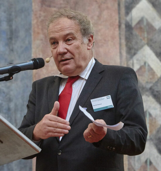 Martin Palous on a podium giving a speech.